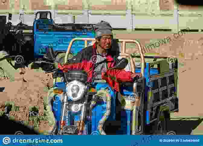 Niall Harbison Riding His Motorbike Through A Tibetan Village Motorbike Travels: Tibet Niall Harbison